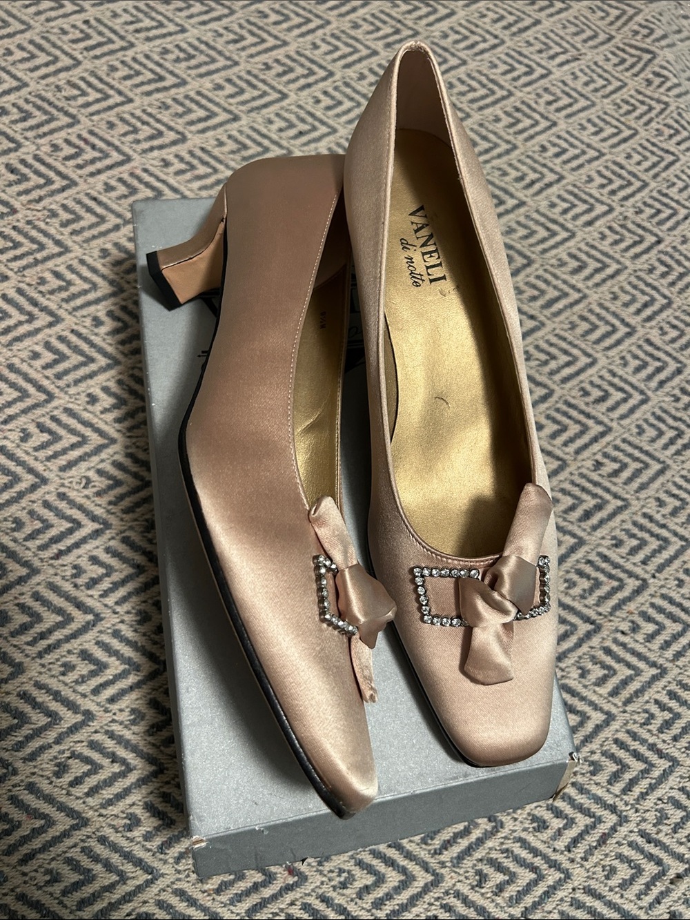 Vaneli Satin Bow with rhinestone accent and leather sole In champagne
